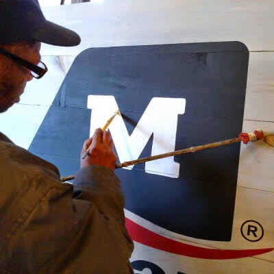 kevin finishes a faux antique sign