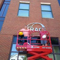A small scissor lift was used to install the the new dimensional logo at Trace offices in Annapolis.
