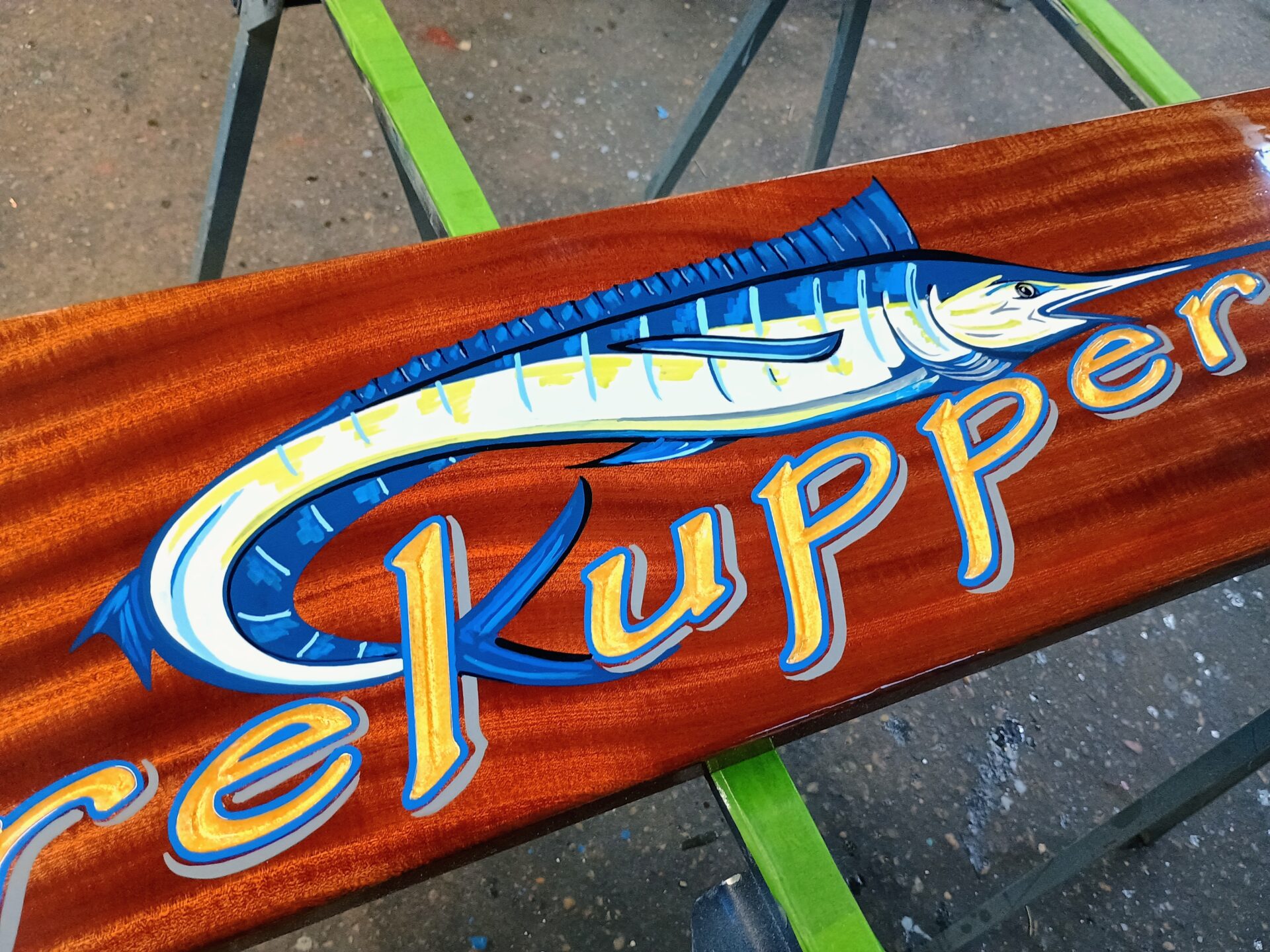 mahogany boat sign with gold leaf lettering and a hand-painted blue marlin