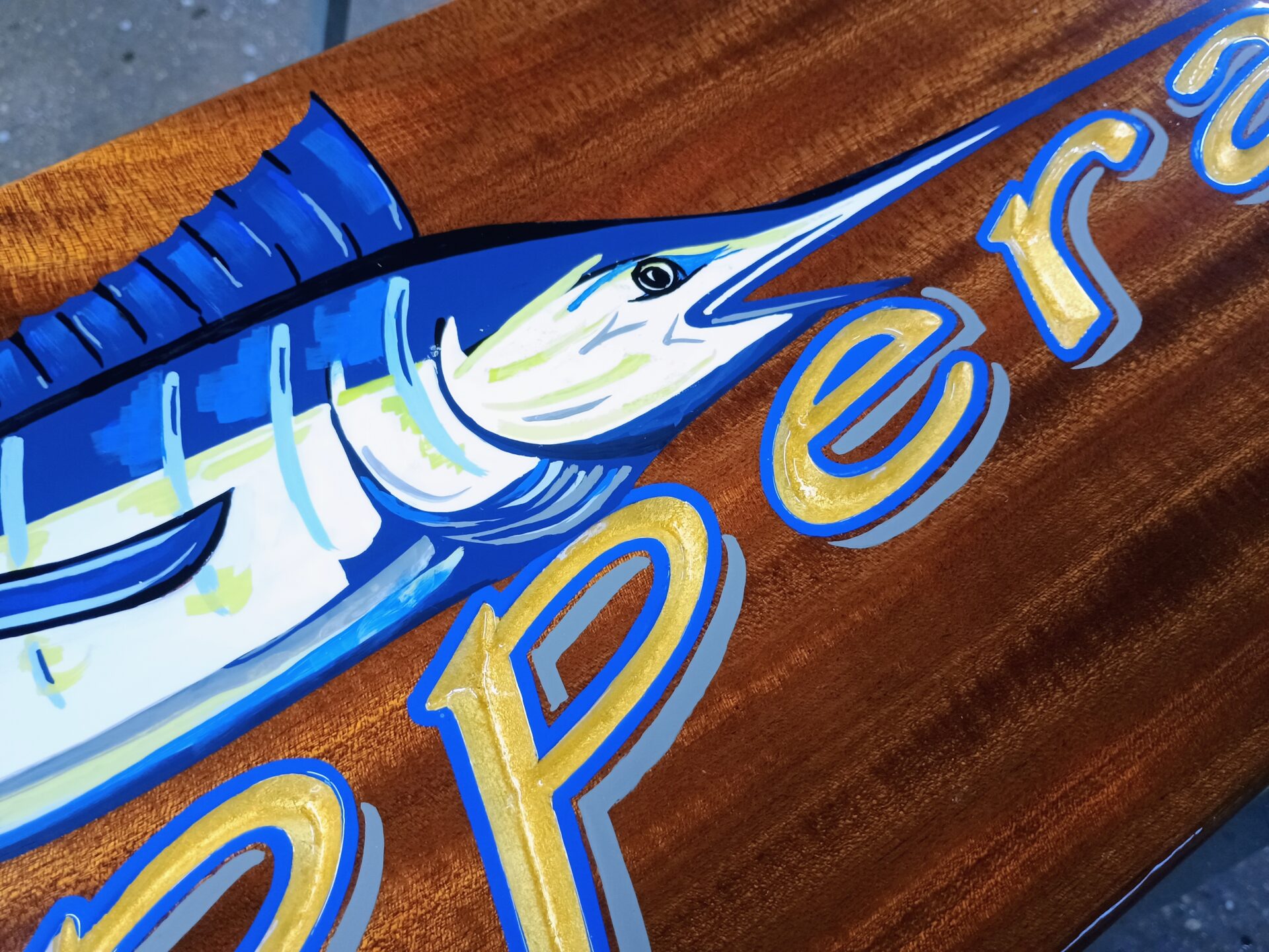 hand-painted blue marlin on a mahogany sign for reKUPPERation