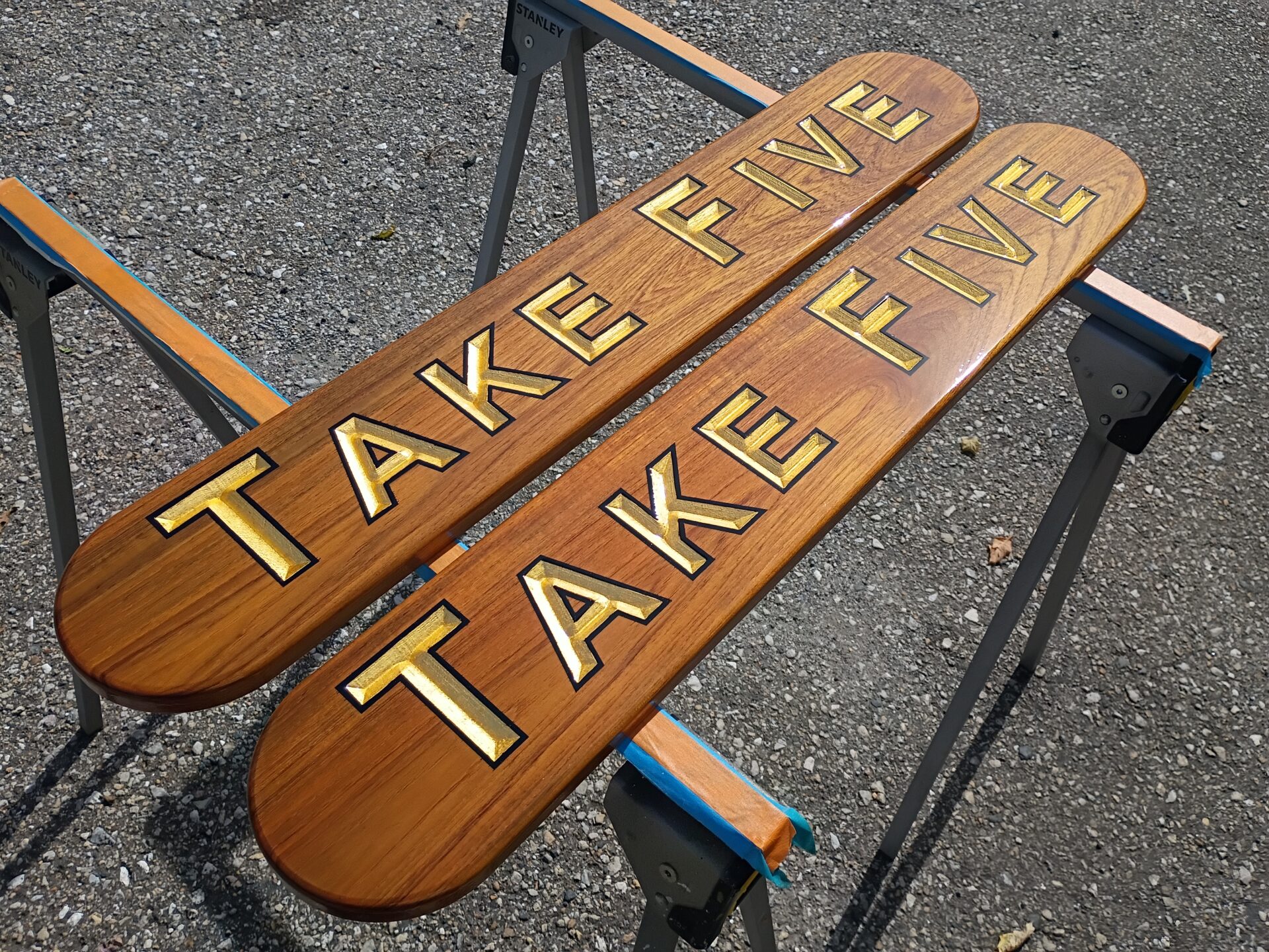 Teak nameboards with carved gold leaf letters and black outline