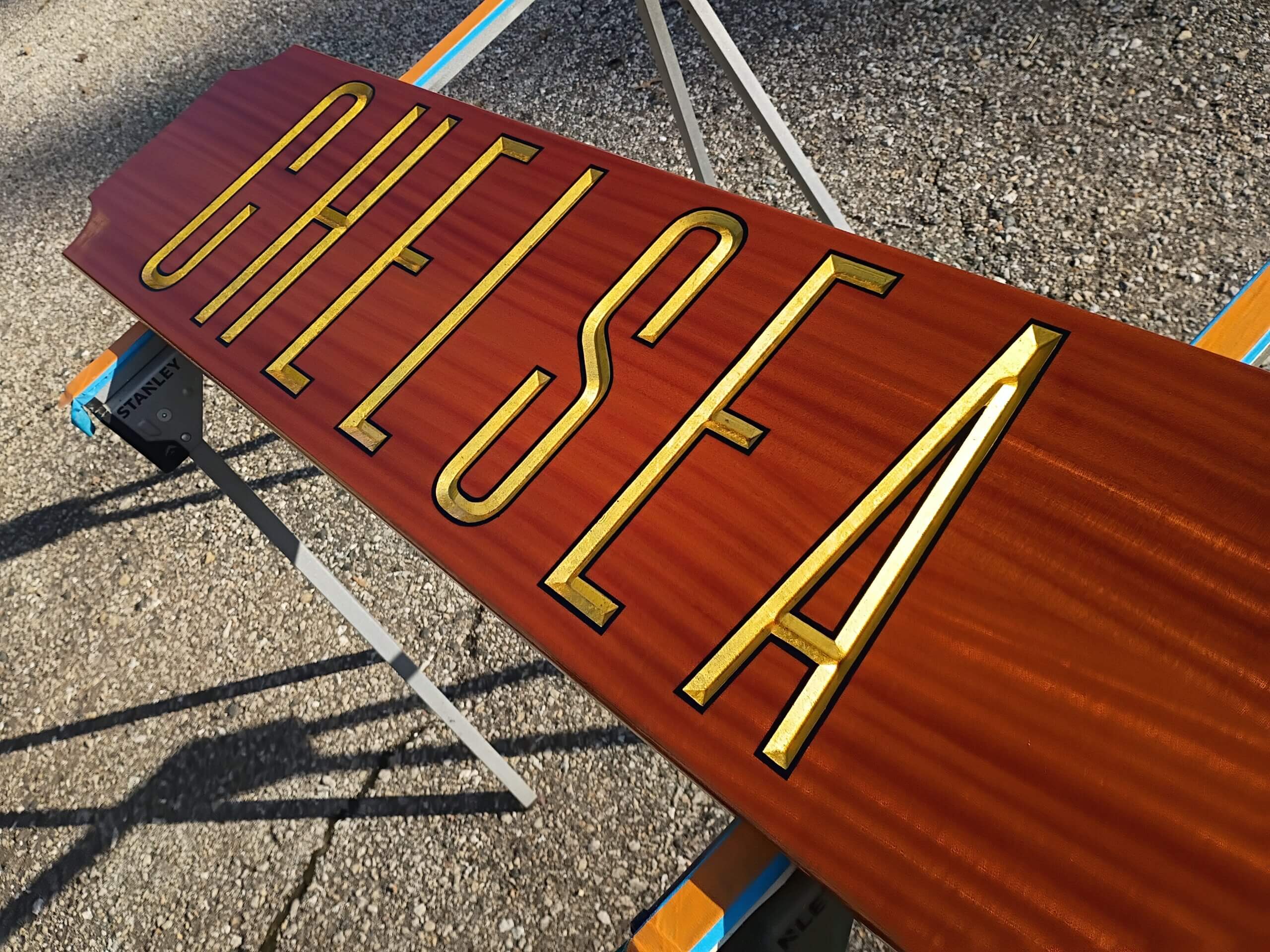 Carved and gilded letters on the Chelsea mahogany quarterboard