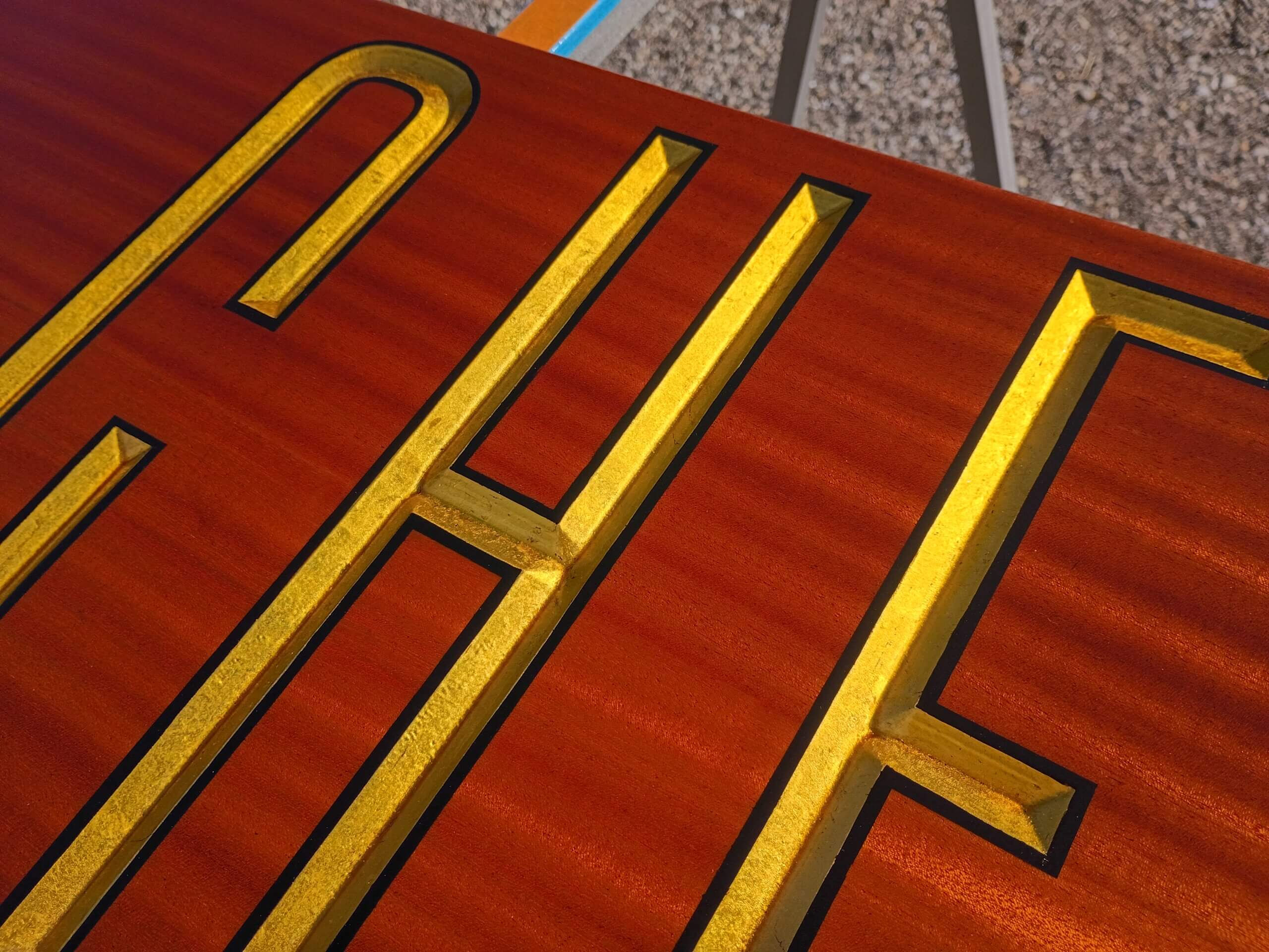 Chelsea mahogany quarterboard with carved gold leaf letters